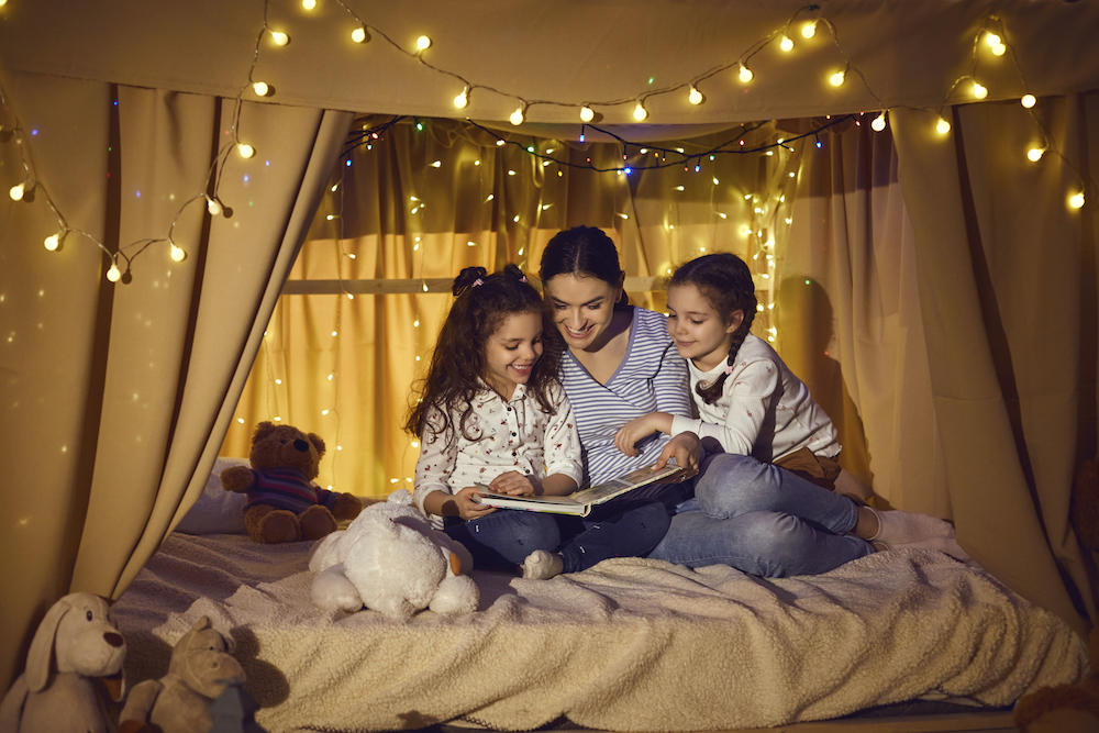 happy family reading a book mom reading to kids